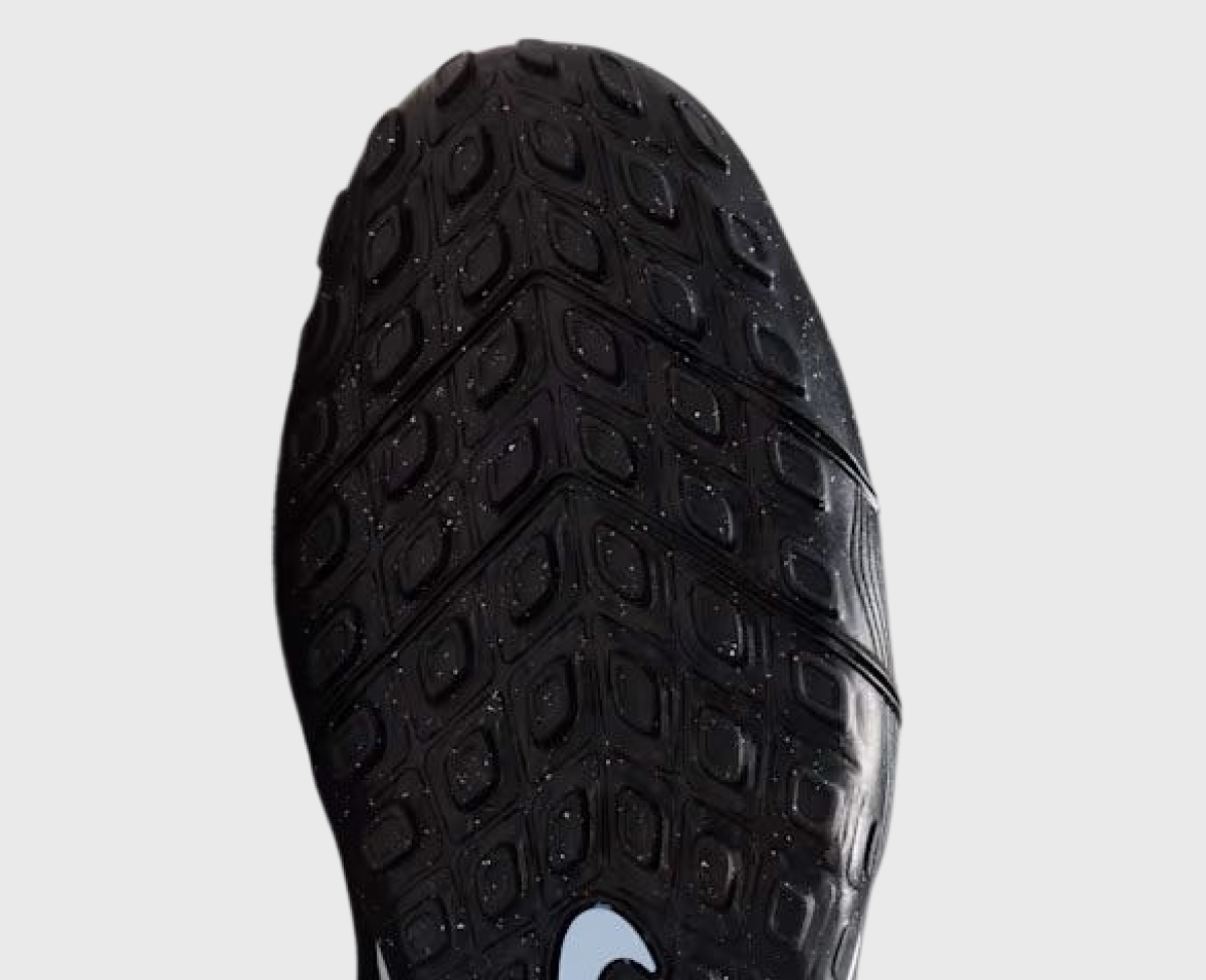 Turf outsole viewed from below — dense rubber nubs designed for older artificial fields with shorter turf